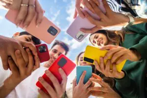 young people looking at social media on their phones