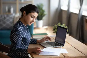 a woman writing b2b content on her laptop 