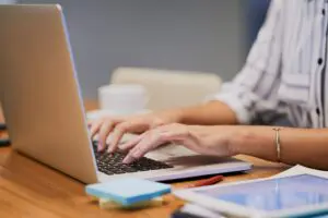 woman writing informative content on a laptop
