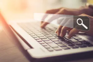 website search bar with person typing on a keyboard