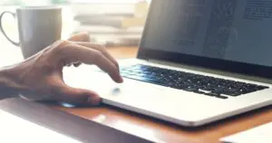 person writing article on a laptop
