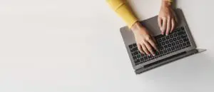 person writing on computer