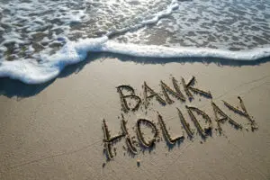 bank holiday written in the sand