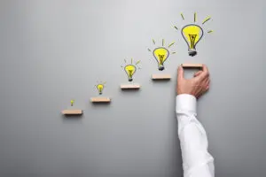 image of 5 steps, each with a light bulb above them, representing a 5 step process