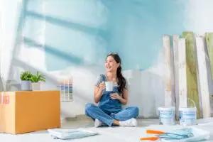 lady sat painting and building decor for her house