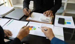 3 people evaluating data and examining the results