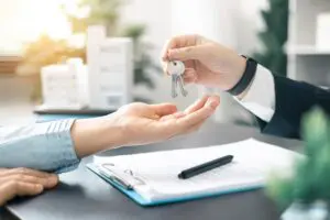 real estate agent handing over keys to new home owner