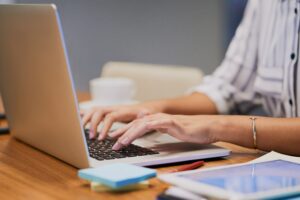 Woman writing informative content on a laptop