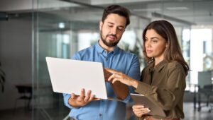 two people looking at a website and examining it