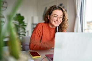 person smiling whilst working as a content marketer