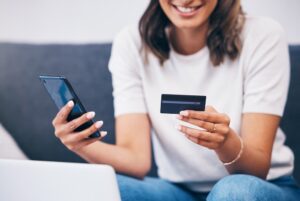 woman paying with credit card on mobile phone