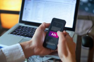 man looking at paid social marketing on his phone