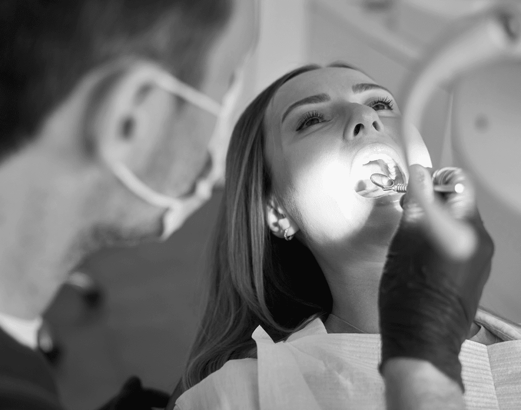 Image of woman with mouth open at dentist to represent a case study for The Dental Law Partnership