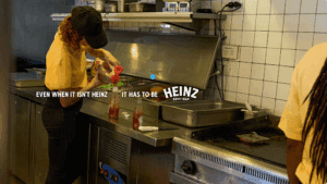 Sauce being poured into a Heinz branded bolttle