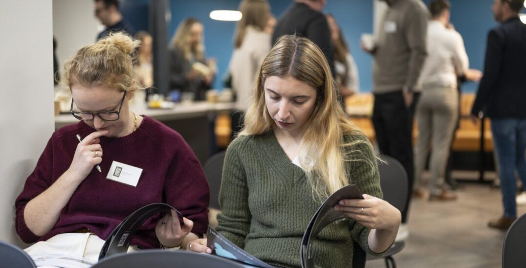 event attendees reading legal report