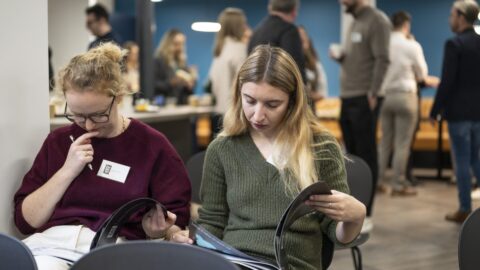 event attendees reading legal report