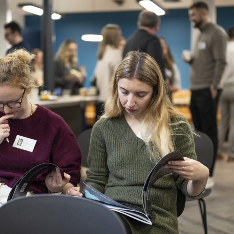 event attendees reading legal report