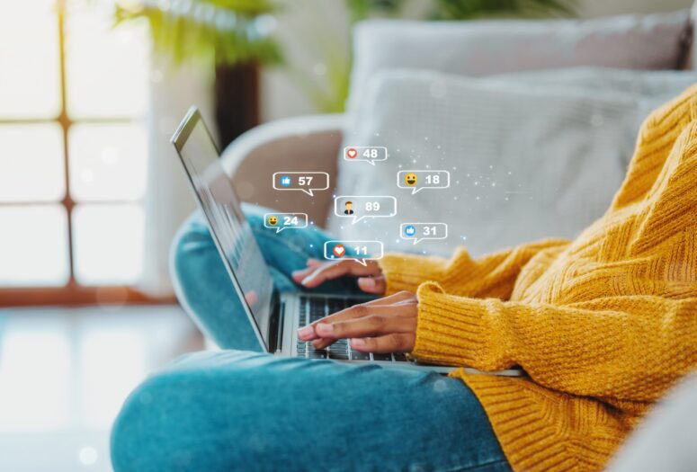 women using social media on laptop