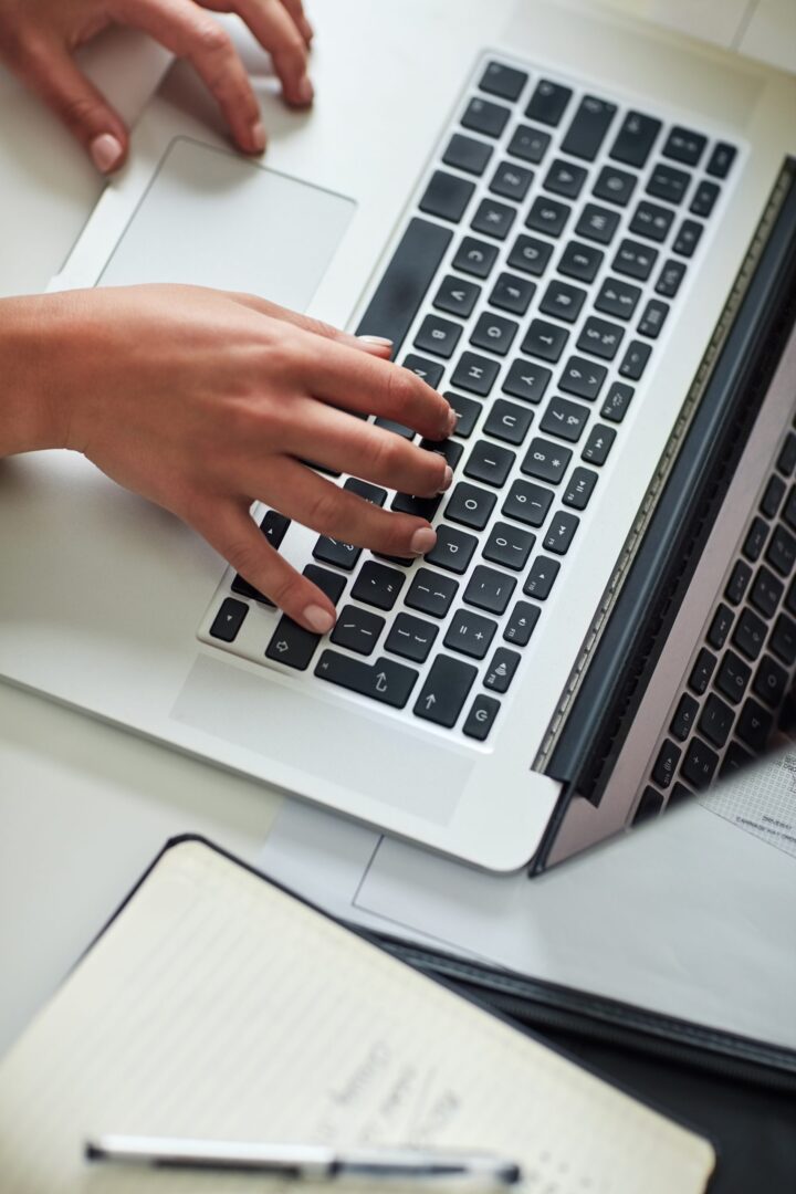 person working on website content on laptop
