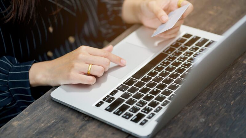 close up woman using laptop for shopping