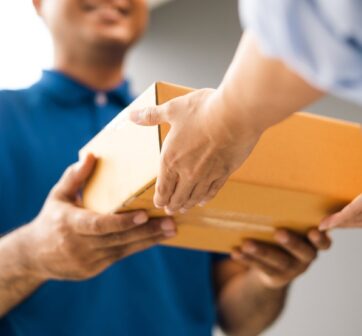 close,up,parcel,in,hand,of,blue,uniform,delivery,man