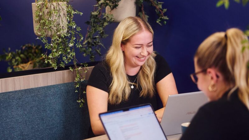 embryo team members working together on desk