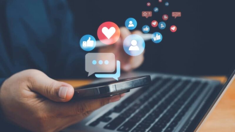 laptop and phone looking using social media