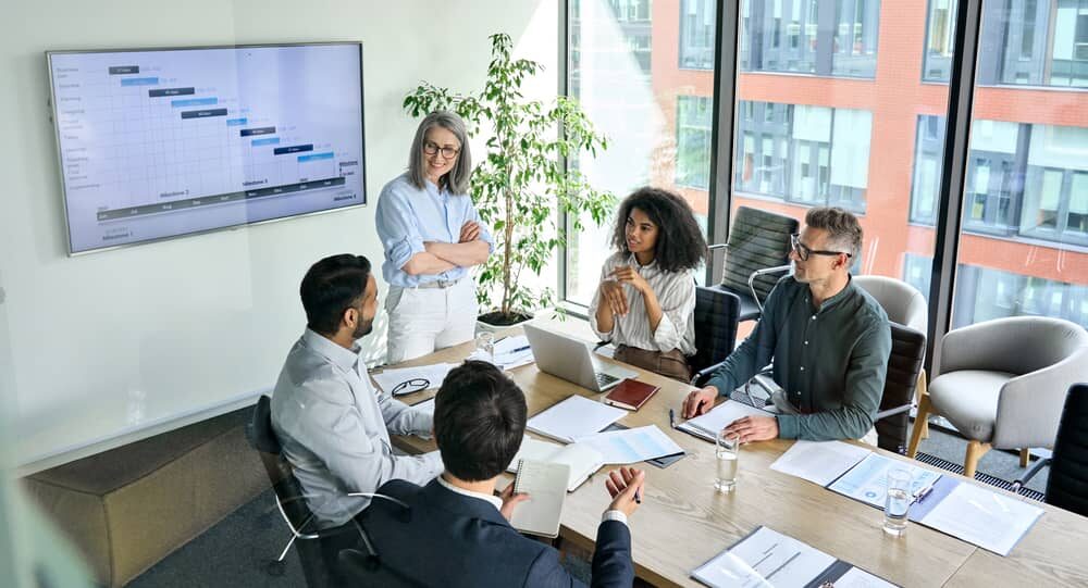 people in a meeting room evaluating a website migration project