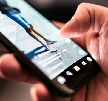 person scrolling on phone and watching video advert