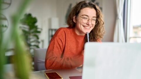 person smiling whilst working as a content marketer